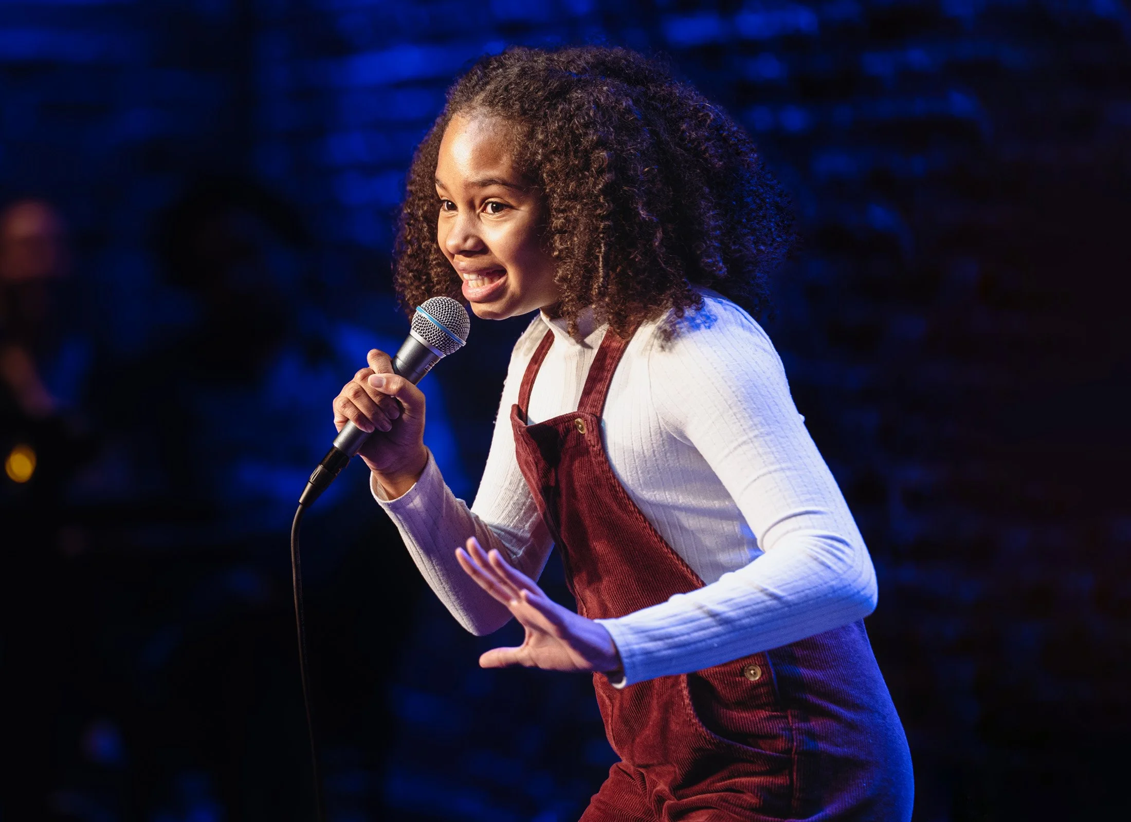A young performer at the microphone on the Ice House stage.