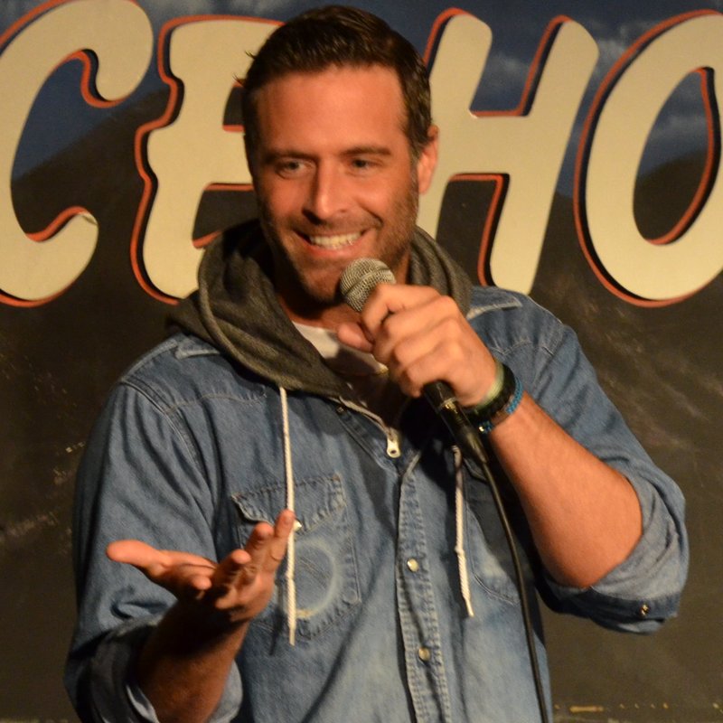 Brady Matthews on stage at a Cool Beans Comedy show.