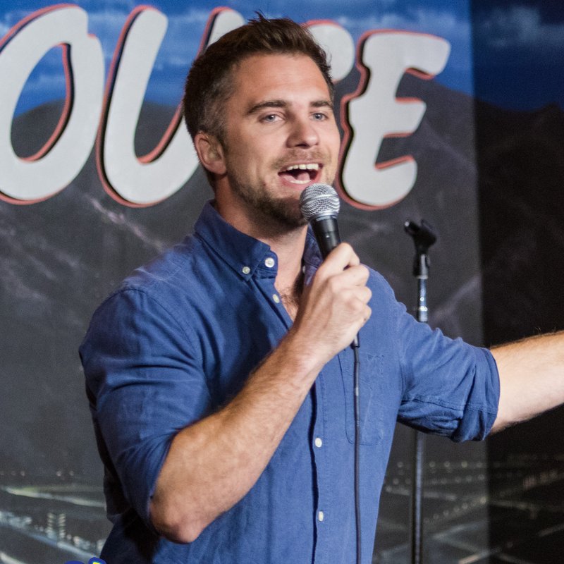 DJ Demers on stage at a Cool Beans Comedy show.