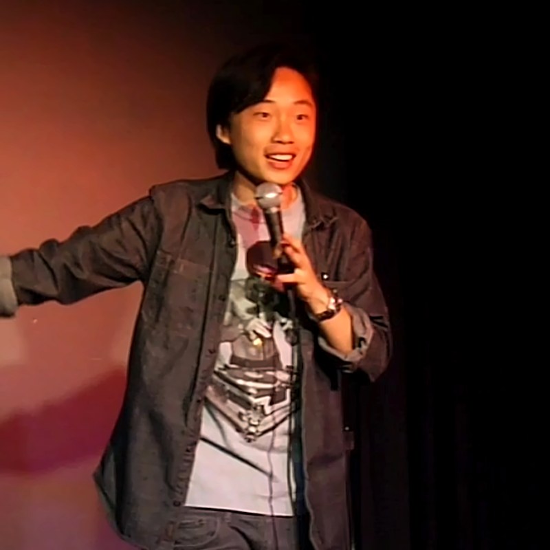 Jimmy O. Yang on stage at a Cool Beans Comedy show.