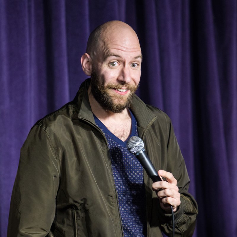 Justin Foster on stage at a Cool Beans Comedy show.