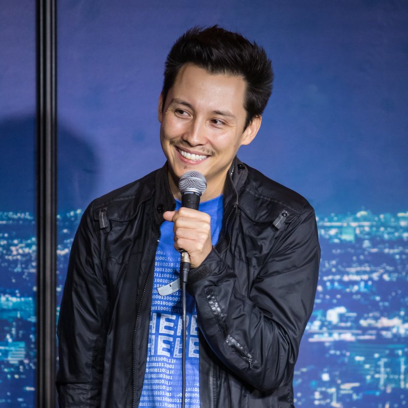 KT Tatara on stage at a Cool Beans Comedy show.