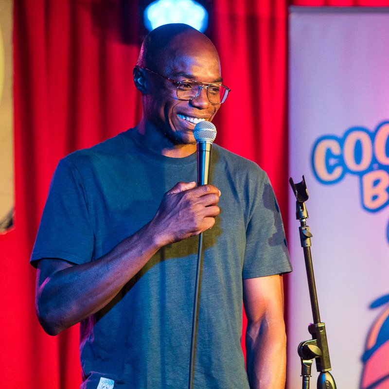 Kyle Grooms on stage at a Cool Beans Comedy show.