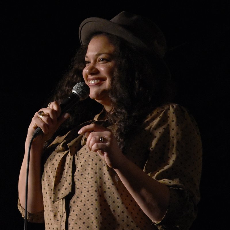 Michelle Buteau on stage at a Cool Beans Comedy show.