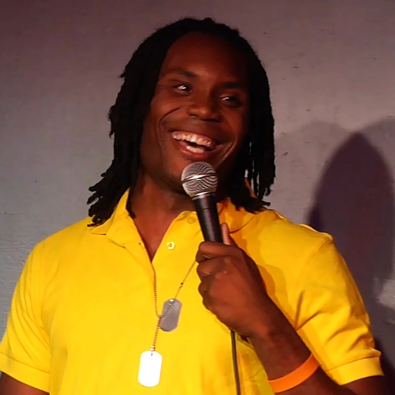 Reggie Jr. on stage at a Cool Beans Comedy show.