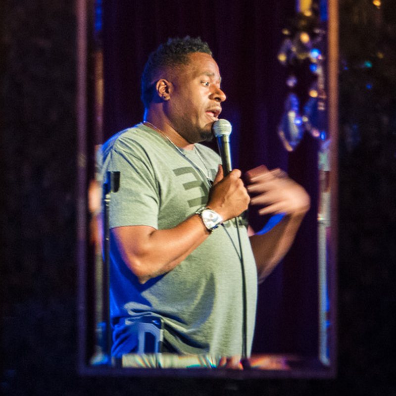 Sean Larkins on stage at a Cool Beans Comedy show.